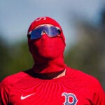 Boston Red Sox first baseman Triston Casas (36) wore a protective coverup from the suns rays. Casas was in camp early before position players are required to report for Boston Red Sox Spring Training at Jet Blue Park in Fort Myers, FL.