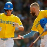 Boston Red Sox left fielder Roman Anthony (19) gets a hand from BBoston Red Sox shortstop Trevor Story (10) as he scores during the fourth inning. The Boston Red Sox host the Tampa Bay Rays Saturday, July 12, 2025 at Fenway Park in Boston, MA.
