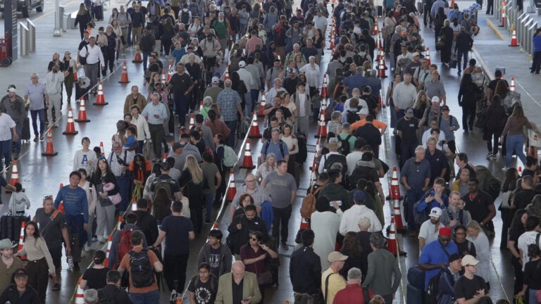 Travelers line up at a TSA checkpoint at George Bush Intercontinental Airport in Houston.