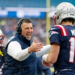 New England Patriots head coach Mike Vrabel celebrates with quarterback Drake Maye (10) after a touchdown during the first half of an NFL football game against the Buffalo Bills, Sunday, Dec. 14, 2025, in Foxborough, Mass.