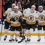 Boston Bruins defenseman Mason Lohrei, second from right, skates back to the bench after scoring against the Seattle Kraken during the third period of an NHL hockey game Tuesday, Jan. 6, 2026, in Seattle.