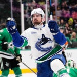 Vancouver Canucks right wing Conor Garland (8) celebrates after scoring in the second period of an NHL hockey game against the Dallas Stars Thursday, Oct. 16, 2025, in Dallas.