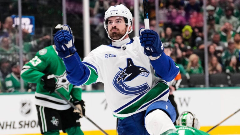 Vancouver Canucks right wing Conor Garland (8) celebrates after scoring in the second period of an NHL hockey game against the Dallas Stars Thursday, Oct. 16, 2025, in Dallas.