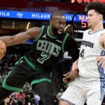 Boston Celtics guard Jaylen Brown (7) drives against Memphis Grizzlies guard Walter Clayton Jr. (4) in the second half of an NBA basketball game Friday, March 20, 2026, in Memphis, Tenn.