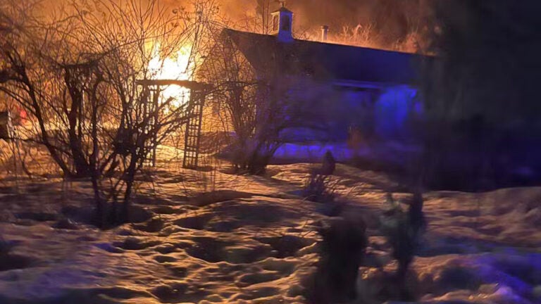 Two officers rescue woman found asleep amid house fire in Merrimac