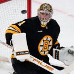 Boston Bruins goaltender Jeremy Swayman (1) eyes the puck after a save against the Los Angeles Kings during the first period of an NHL hockey game, Tuesday, March 10, 2026, in Boston.