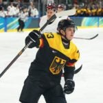 MILAN, ITALY - FEBRUARY 14: Lukas Reichel #73 of Team Germany celebrates scoring a goal in the first period during the Men's Preliminary Group C match between Germany and Latvia on day eight of the Milano Cortina 2026 Winter Olympic games at Milano Rho Ice Hockey Arena on February 14, 2026 in Milan, Italy.