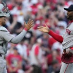 Boston Red Sox pitcher Aroldis Chapman, right, celebrates with catcher Carlos Narváez after winning an opening-day baseball game against the Cincinnati Reds in Cincinnati, Thursday, March 26, 2026.