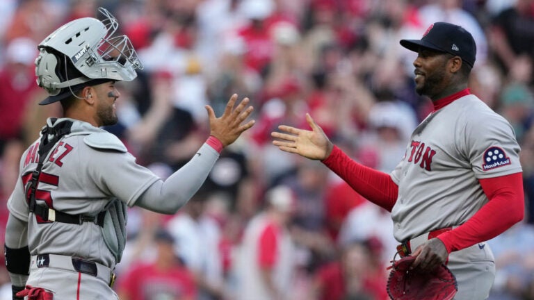 Boston Red Sox pitcher Aroldis Chapman, right, celebrates with catcher Carlos Narváez after winning an opening-day baseball game against the Cincinnati Reds in Cincinnati, Thursday, March 26, 2026.