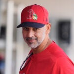 Boston Red Sox manager Alex Cora watches from the dugout before a spring training baseball game against the Minnesota Twins in Fort Myers, Fla., Saturday, Feb. 21, 2026.