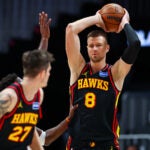 Atlanta Hawks center Kristaps Porzingis (8) looks to pass during the first half of an NBA basketball game against the Minnesota Timberwolves, Wednesday, Dec. 31, 2025, in Atlanta.