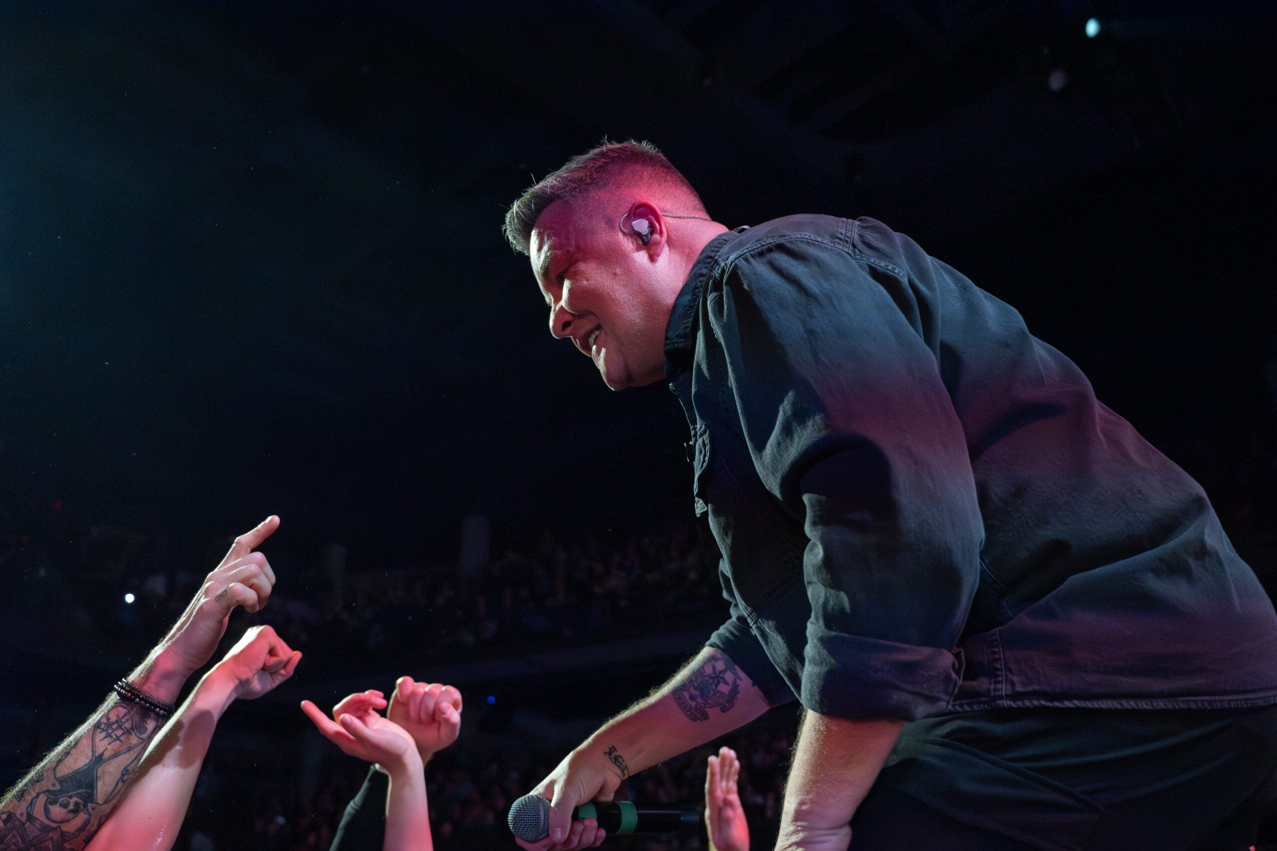 Dropkick Murphys' lead singer Ken Casey leans into the crowd.