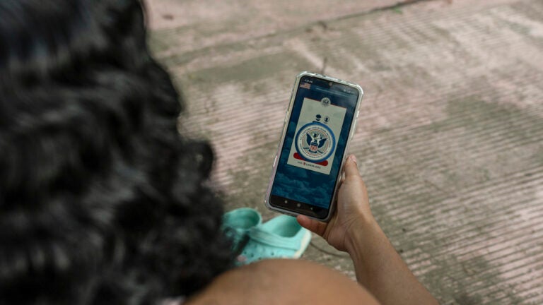 A woman uses the CBP One mobile app.