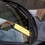 The fake parking violations have a QR code prompting victims to pay a fine.
