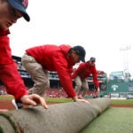 The Fenway Park field crew prepare the field before the season home opener against the San Diego Padres on April 3, 2026 in Boston.