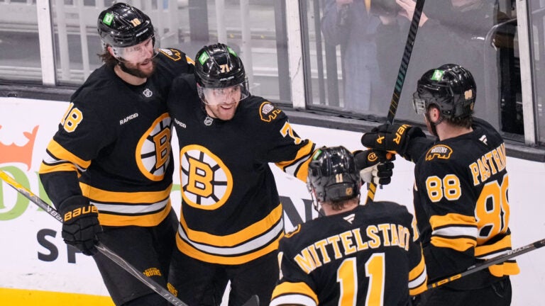 Boston Bruins left wing Viktor Arvidsson, center, is congratulated after his goal against Dallas Stars goaltender Jake Oettinger (29) during the first period of an NHL hockey game, Tuesday, March 31, 2026, in Boston.