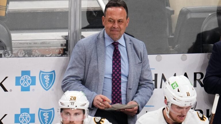 Boston Bruins head coach Marco Sturm stands behind his bench during overtime of an NHL hockey game against the Pittsburgh Penguins in Pittsburgh, Sunday, March 8, 2026.