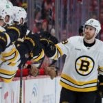 Boston Bruins center Elias Lindholm (28) celebrates with teammates after scoring against the Detroit Red Wings during the third period of an NHL hockey game Saturday, March 21, 2026, in Detroit.