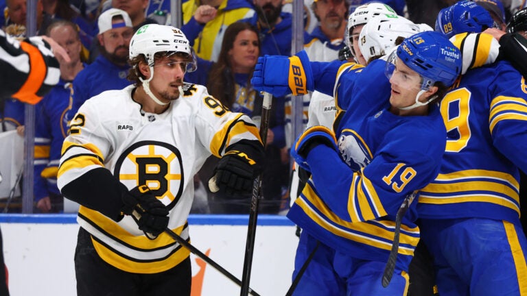 Boston Bruins center Marat Khusnutdinov (92) and Buffalo Sabres center Peyton Krebs (19) battle after a whistle during the first period in Game 1 of a first-round NHL hockey Stanley Cup playoff series Sunday, April 19, 2026, in Buffalo, N.Y.