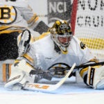 Boston Bruins goaltender Jeremy Swayman (1) makes a save in traffic during the first period in Game 2 of a first-round NHL hockey Stanley Cup playoff series against the Buffalo Sabres Tuesday, April 21, 2026, in Buffalo, N.Y.