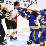 Boston Bruins defenseman Nikita Zadorov (91) and Buffalo Sabres right wing Alex Tuch (89) fight during the third period in Game 2 of a first-round NHL hockey Stanley Cup playoff series Tuesday, April 21, 2026, in Buffalo, N.Y.