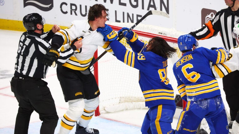 Boston Bruins defenseman Nikita Zadorov (91) and Buffalo Sabres right wing Alex Tuch (89) fight during the third period in Game 2 of a first-round NHL hockey Stanley Cup playoff series Tuesday, April 21, 2026, in Buffalo, N.Y.
