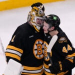 Boston Bruins goaltender Jeremy Swayman (1) is congratulated by center James Hagens (44) after a win against the New Jersey Devils following a hockey game, Tuesday, April 14, 2026, in Boston. (AP Photo/Charles Krupa)