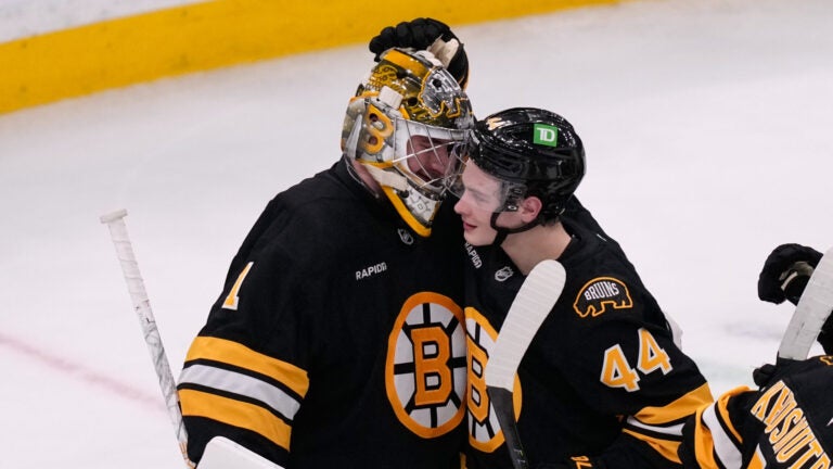 Boston Bruins goaltender Jeremy Swayman (1) is congratulated by center James Hagens (44) after a win against the New Jersey Devils following a hockey game, Tuesday, April 14, 2026, in Boston. (AP Photo/Charles Krupa)