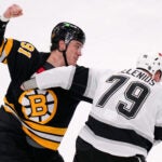 Boston Bruins defenseman Nikita Zadorov (91) fights Los Angeles Kings center Samuel Helenius (79) during the second period of an NHL hockey game, Tuesday, March 10, 2026, in Boston.