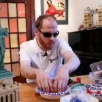Matthew Shifrin, the founder of Bricks for the Blind, feels for specific pieces while building a LEGO gumball machine.