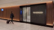 Two-story American Express lounge with terrace opening at Logan