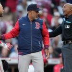 Boston Red Sox manager Alex Cora, center, and Boston Red Sox's Trevor Story, left, dispute a call with home plate umpire CB Bucknor before Cora is ejected during the eighth inning of a baseball game against the Cincinnati Reds in Cincinnati, Saturday, March 28, 2026.