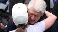 Hillary and Bill Clinton cheer on Chelsea at Boston Marathon