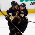 Boston Bruins right wing David Pastrnak (88) and Boston Bruins center Morgan Geekie (39) celebrate Geekie’s goal to tie the score during the third period at TD Garden on Oct. 21, 2025.