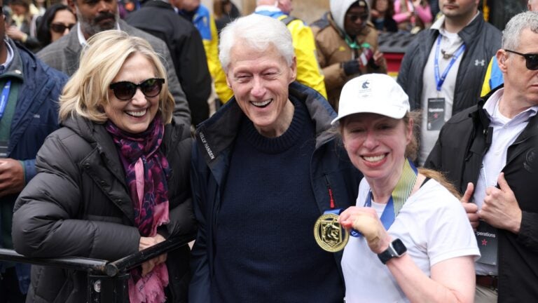 Former U.S. President Bill Clinton, former Secretary of State Hillary Clinton, and Chelsea Clinton pose after Chelsea finished the 130th Boston Marathon on April 20, 2026.