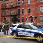 Boston police officers investigate a fatal shooting on Hemenway Street near the Northeastern University campus.