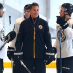The Bruins held a practice and media day at Warrior Arena as they prepare for their season debut Thursday. Coach Bruce Cassidy smiles as he chats with David Krejci(left) and David Pastrnak.