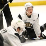 James Hagens, center, a Boston College center and the Bruins’ 7th overall draft pick, stretches with teammates at the conclusion of the first day of Bruins Development Camp at Warrior Arena in Brighton on Monday, June 30, 2025.