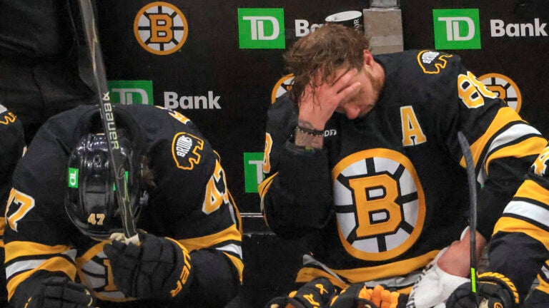 Boston Bruins center Mark Kastelic (47) and right wing David Pastrnak (88) on their bench down 6-0 after a fight against the Buffalo Sabres during third period NHL action of game four in the first round of playoffs at TD Garden on Sunday April 26, 2026.