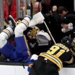 Bruins defenseman Nikita Zadorov, right, sends Sabres defensemanOwen Power into the bench during the first period against the Sabres on Saturday, October 11, 2025.