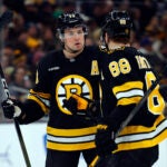 Boston Bruins defenseman Charlie McAvoy (73) and right wing David Pastrnak (88) talk on the ice during the first period at TD Garden on March 3, 2026 in Boston.