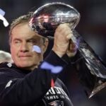 Patriots head coach Bill Belichick holds up the Vince Lombardi Trophy as he celebrates after the Patriots defeated the Seattle Seahawks 28-24 in NFL Super Bowl XLIX football game Sunday, Feb. 1, 2015, in Glendale, Ariz.