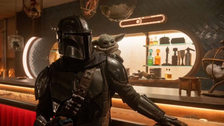 Mandalorian (Pedro Pascal) and Grogu in "The Mandalorian and Grogu."