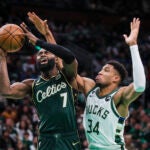 Boston Celtics guard Jaylen Brown (7) is fouled by Milwaukee Bucks forward Giannis Antetokounmpo (34) during third quarter of Sunday’s game on Christmas at TD Garden.