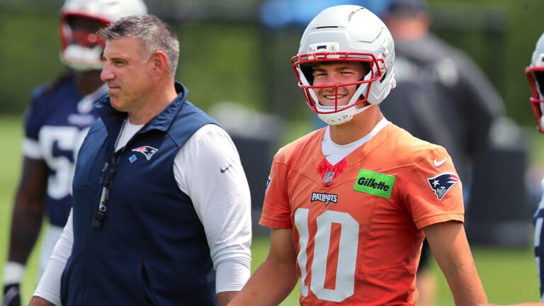 The New England Patriots held OTA’s at their practice field. QB Drake Maye walks beside coach Mike Vrabel.