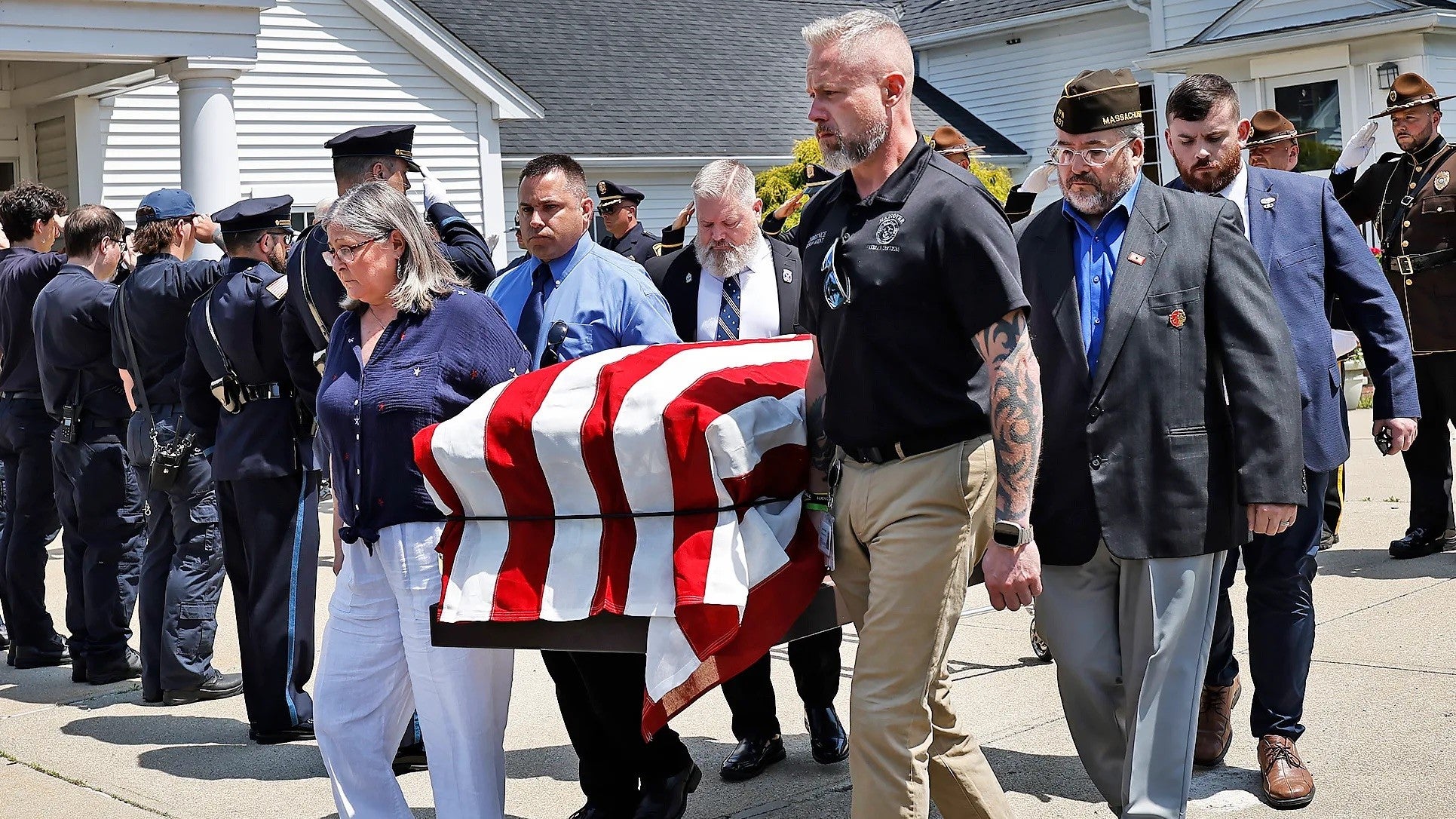 Pallbearers carry Arnold to his final resting place.