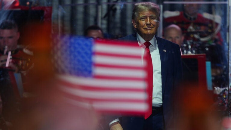 President Donald Trump stands on stage.