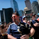 Ross Hardie of Glasgow, Scottland plays his bagpipes while waiting to board his train at South Station in Boston, MA on June 13, 2026. Soccer fans were heading to the 2026 World Cup Group C match between Haiti and Scotland at Boston Stadium in Foxborough.