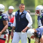 Foxborough 06/02/2026 The New England Patriots held practice at their practice field at Gillette Stadium Tuesday. Coach Mike Vrabel looks over his players during warmups.