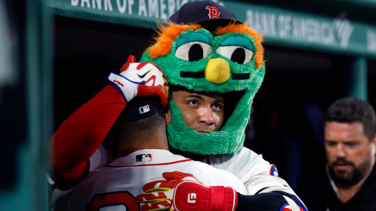 Boston Red Sox first baseman Willson Contreras (right) hugs designated hitter Jahmai Jones (37) after hitting a solo home run during the fifth inning at Fenway Park on Aug. 17, 2026, in Boston.
